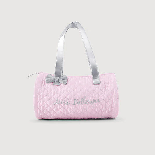 Pink quilted bag with silver handle on a light gray background