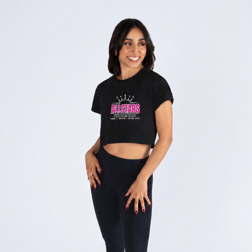 Woman wearing a black crop top and leggings with a logo on a white background