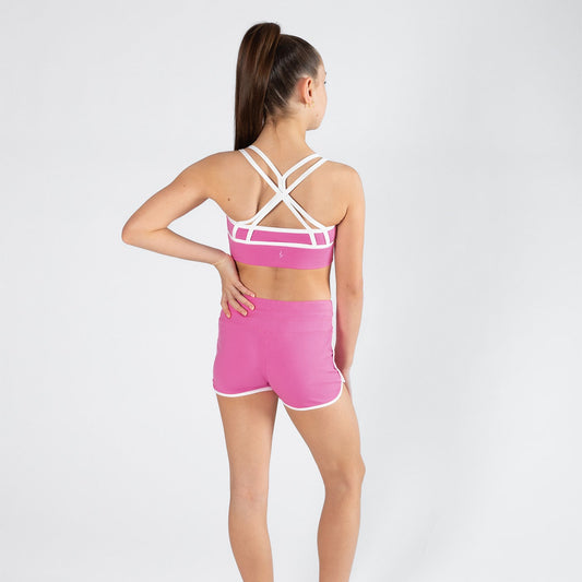 Person wearing a pink sports outfit with a white background