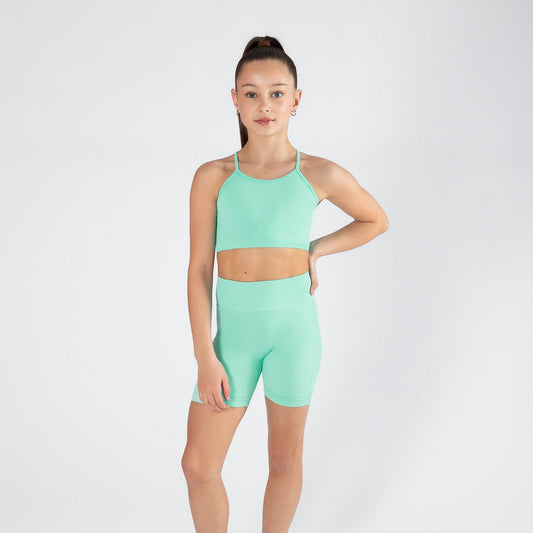 Person wearing a mint green athletic outfit on a white background