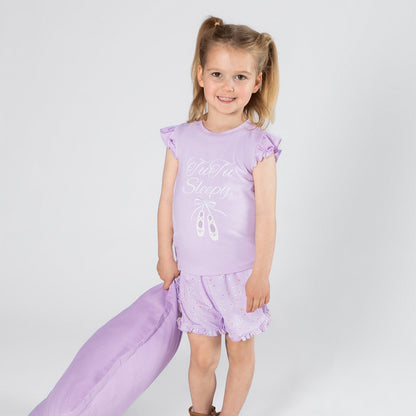 Young girl in a purple outfit with text on a white background
