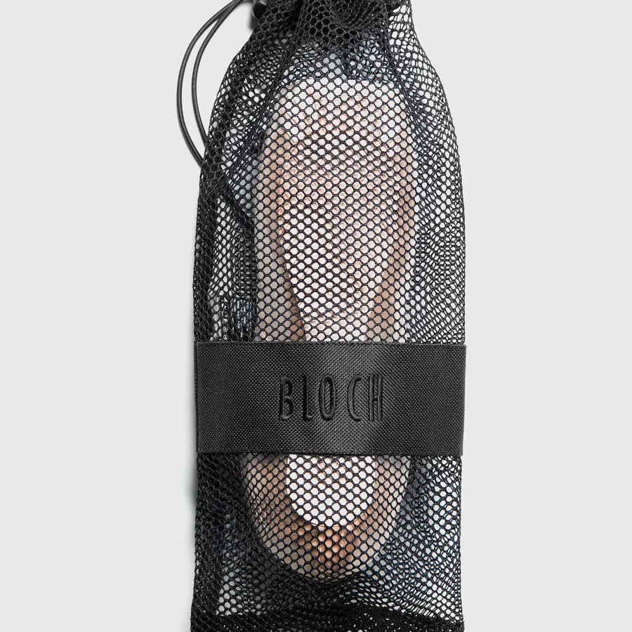 Black mesh drawstring bag with 'BLOCH' branding holding a pair of ballet shoes on a light gray background.
