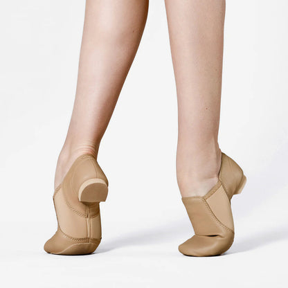 Tan jazz shoes worn on a white background