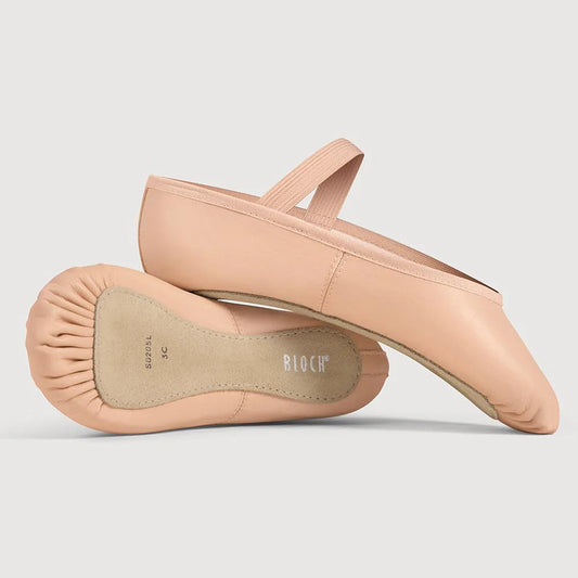 Pair of beige ballet flats on a light gray background