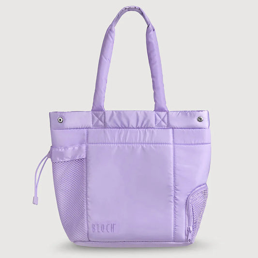 A light purple/lavender tote bag with dual top handles, a front zip pocket, mesh side pockets, and a subtle 'BLOOM' logo near the bottom, shown on a solid light gray background.