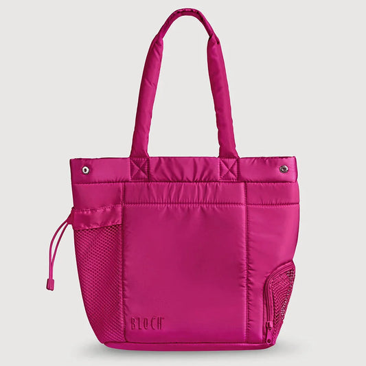 A bright pink puffy tote bag with dual top handles, a front zip pocket, mesh side pockets, and a drawstring detail, shown against a light gray background.